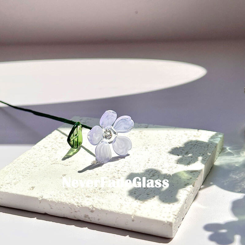 purple flower in glass